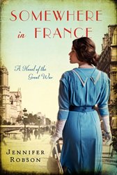 The cover of the book Somewhere in France by Jennifer Robson. A woman dressed in a blue dress that evokes the 1910s looks  out over a sepia toned image of a French street from the same era
