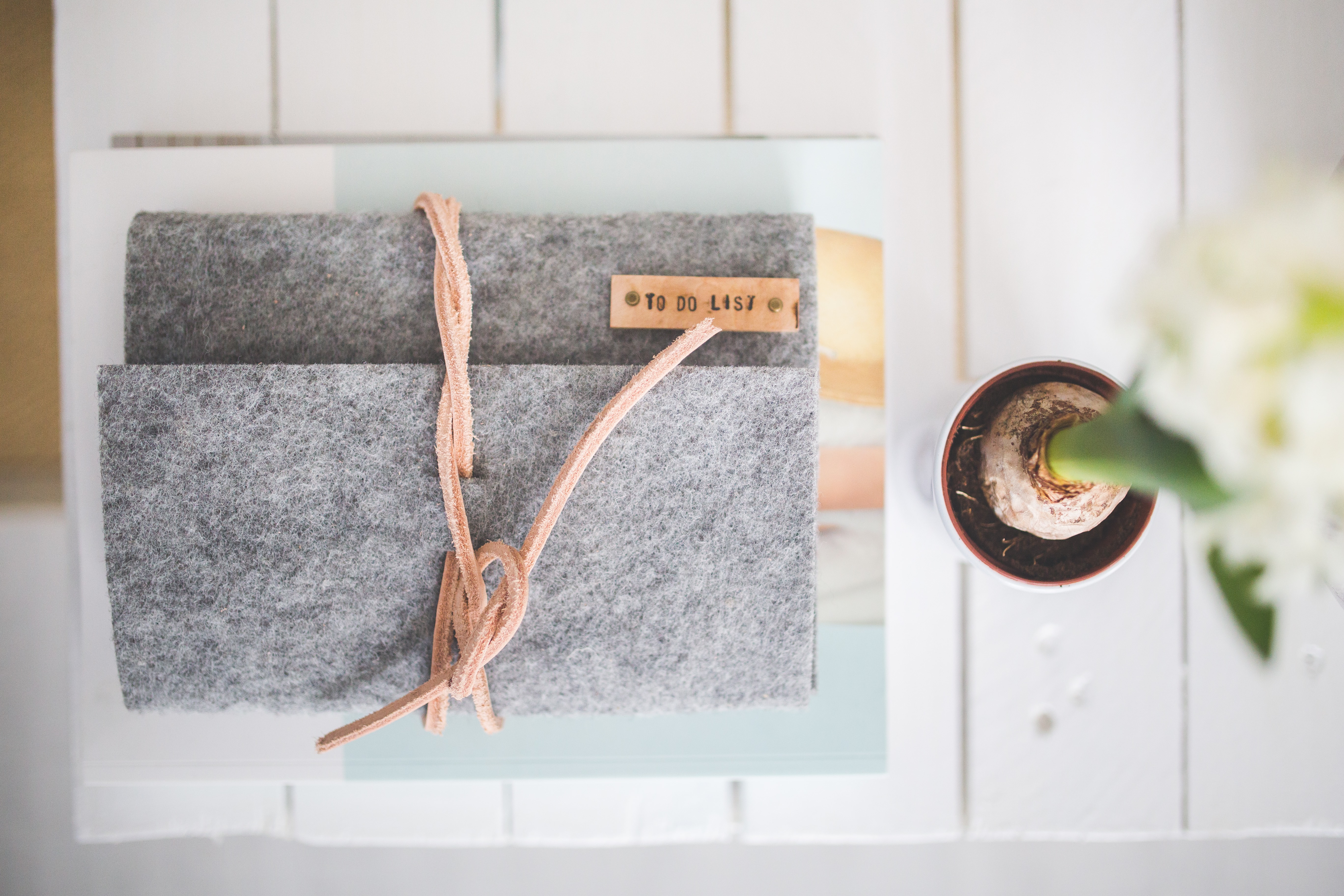 a grey felt journal with the words to do list on it