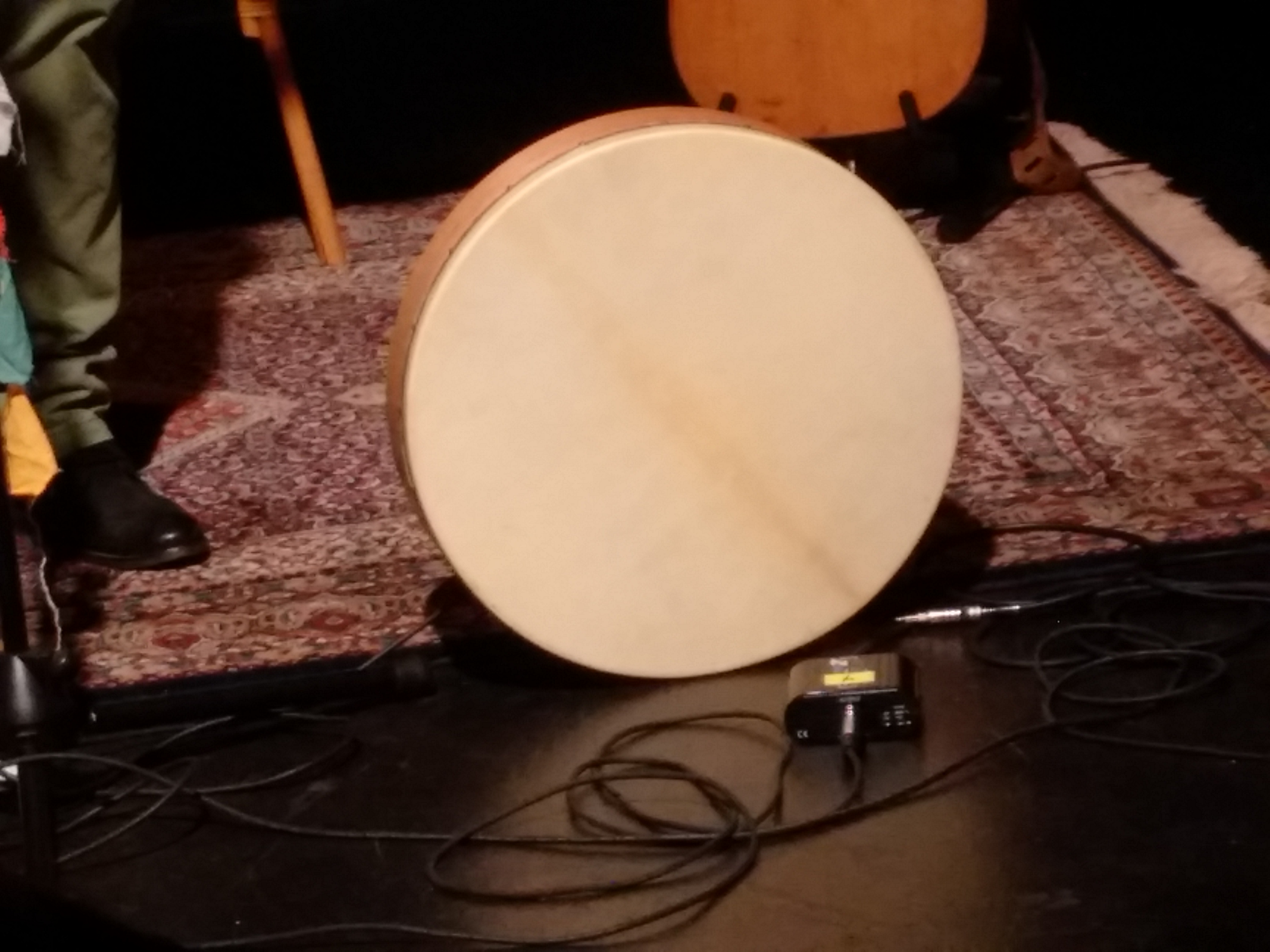 A closeup of a Bodhran - a round wooden drum with a smooth white head, meant to be held in the hand