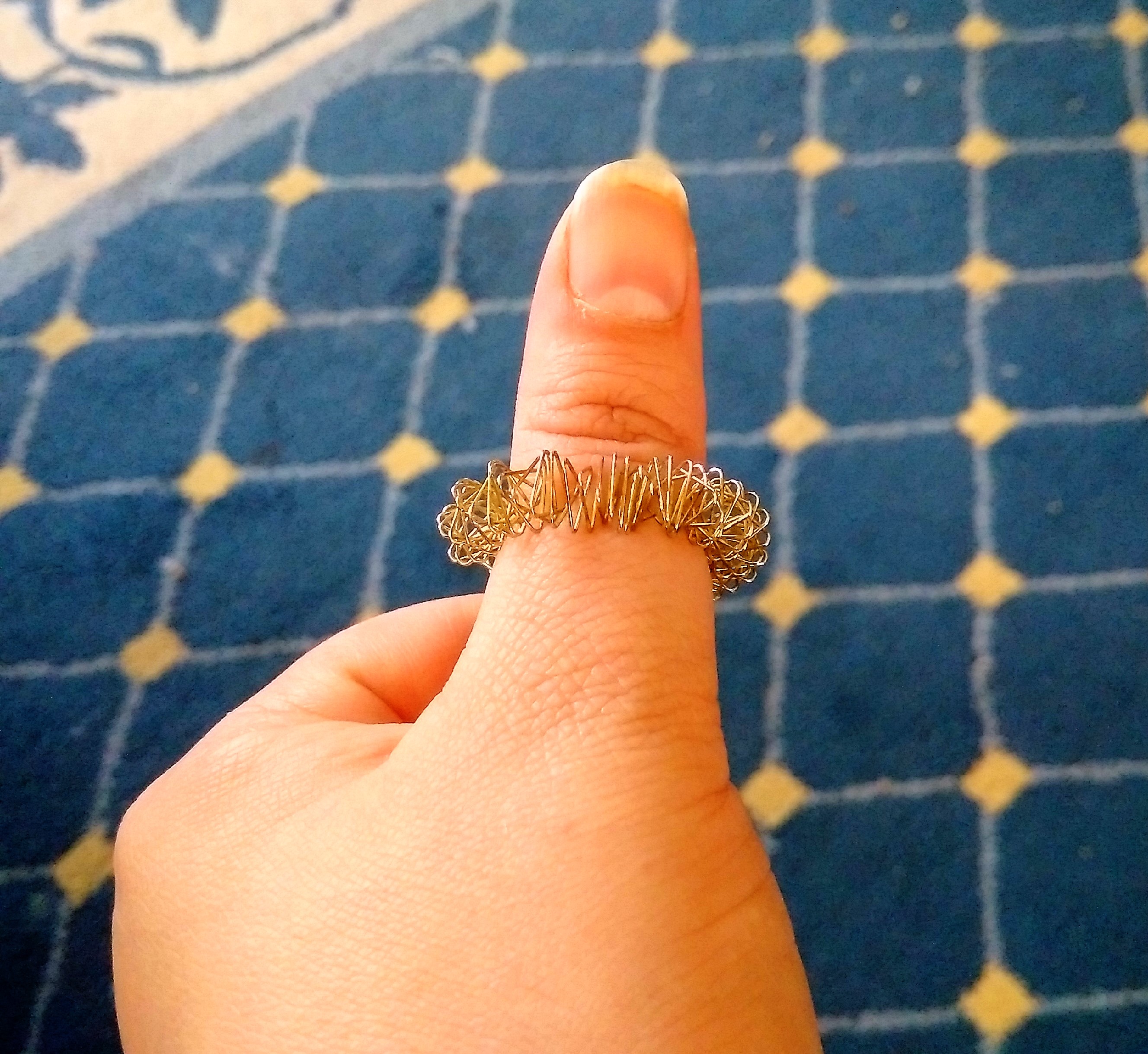 a ring on a finger that is made out of coiled wire in a spring formation