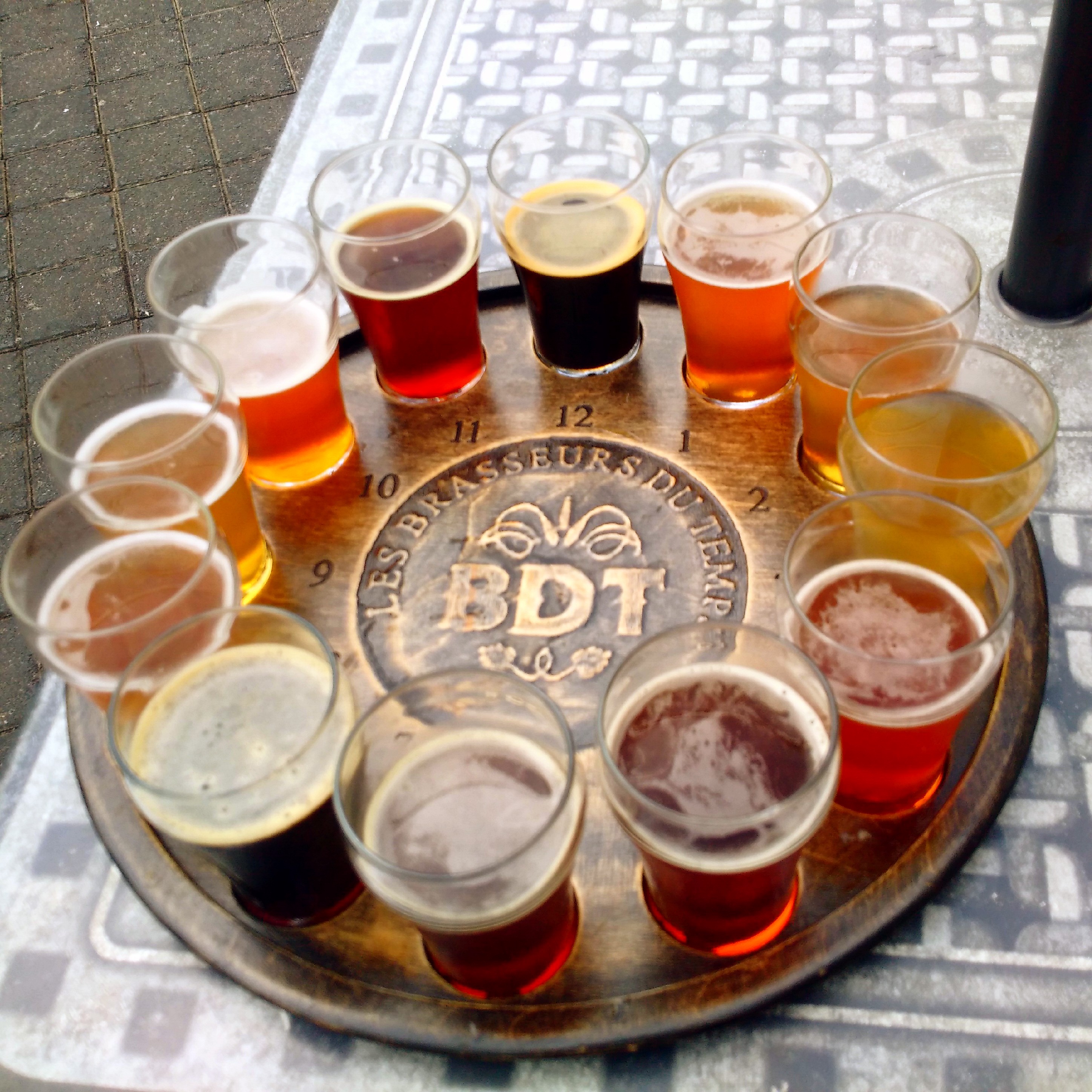 12 Beer sampler glasses on a round platter in the style of a clock